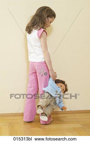 rear view of young girl holding doll View Large Photo Image Stock Image - rear view of young girl holding doll. Fotosearch