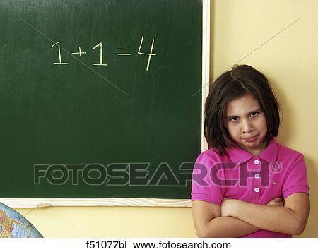 Sad girl standing in front of blackboard View Large Photo Image Stock Image - Sad girl standing in front of blackboard. Fotosearch