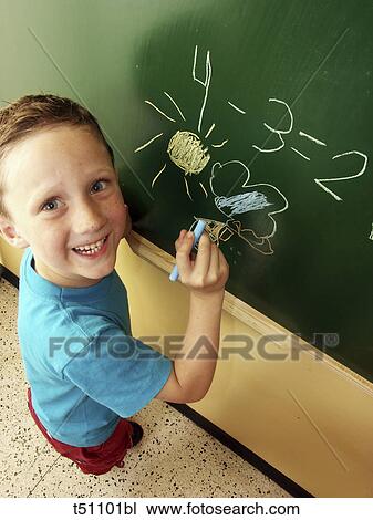 Schoolboy drawing on blackboard View Large Photo Image Stock Image - Schoolboy drawing on blackboard. Fotosearch