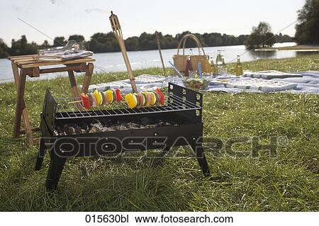 still life of barbecue with table and shashlik on charcoal grill View Large Photo Image Stock Image - still life of barbecue with table and shashlik on charcoal grill. Fotosearch