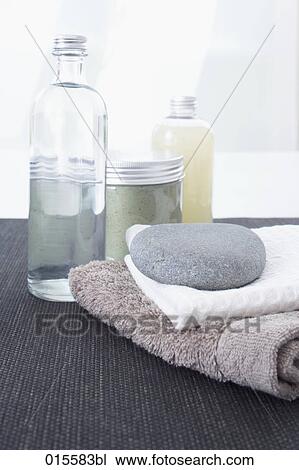 still life of cosmetic bottles towels and pebble View Large Photo Image Stock Image - still life of cosmetic bottles towels and pebble. Fotosearch