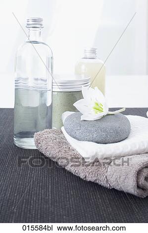 still life of cosmetic bottles towels pebble and flower View Large Photo Image Stock Image - still life of cosmetic bottles towels pebble and flower. Fotosearch