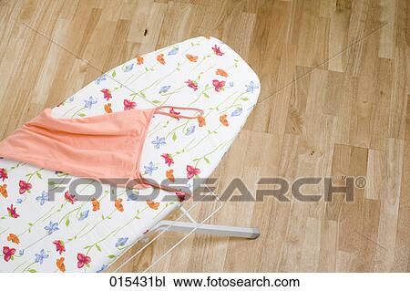 still life of orange top on ironing board View Large Photo Image Stock Image - still life of orange top on ironing board. Fotosearch