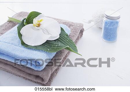 Stock Image - still life of orchid towels and bath salts. Fotosearch