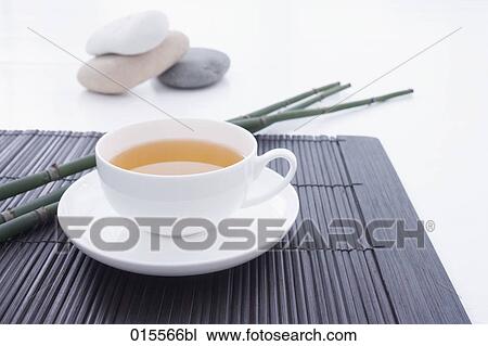 still life of tea cup on straw mat with three pebbles in background View Large Photo Image Stock Image - still life of tea cup on straw mat with three pebbles in background. Fotosearch