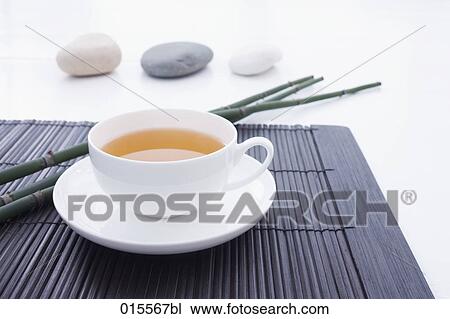 still life of tea cup on straw mat with three pebbles in background View Large Photo Image Stock Image - still life of tea cup on straw mat with three pebbles in background. Fotosearch