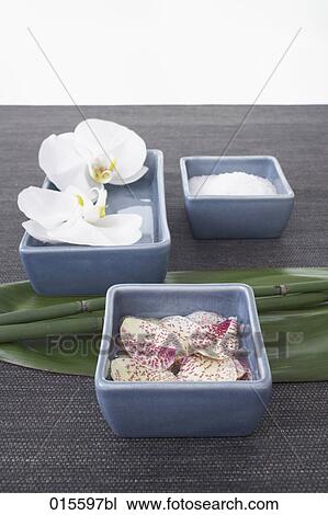 Stock Image - still life of three blue bowls with orchids. Fotosearch
