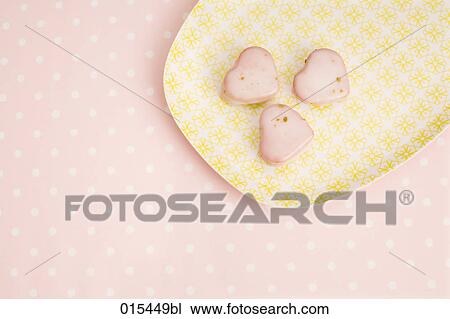 still life of three heart shaped cookies on yellow plate View Large Photo Image Stock Image - still life of three heart shaped cookies on yellow plate. Fotosearch