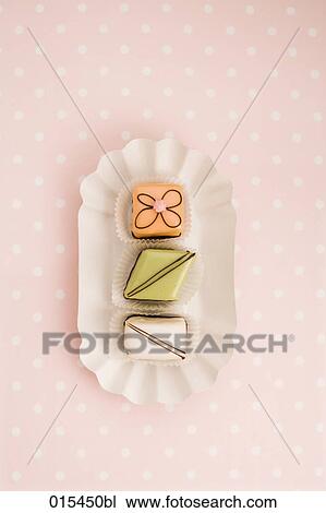 still life of three petit fours on paper plate View Large Photo Image Stock Image - still life of three petit fours on paper plate. Fotosearch