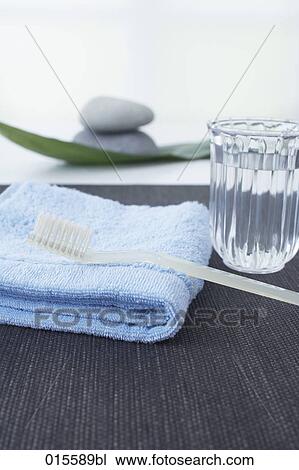 still life of toothbrush on towel and glass of water View Large Photo Image Stock Image - still life of toothbrush on towel and glass of water. Fotosearch