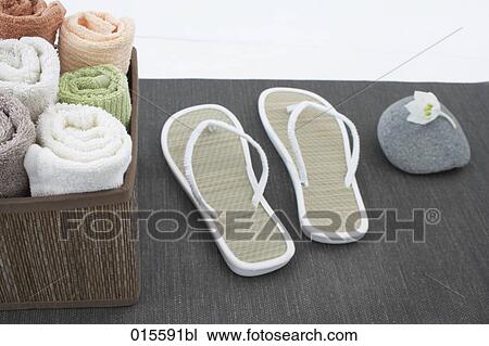 still life of towels in basket and pair of flip flops View Large Photo Image Stock Image - still life of towels in basket and pair of flip flops. Fotosearch