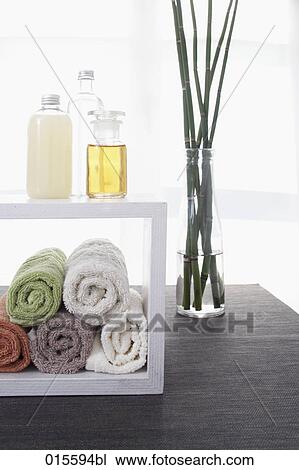 still life of towels in shelf cosmetic bottles and bamboo in vase View Large Photo Image Stock Image - still life of towels in shelf cosmetic bottles and bamboo in vase. Fotosearch