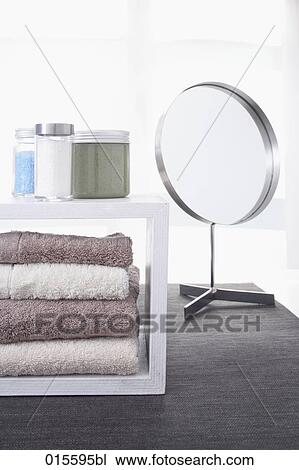 still life of towels in shelf cosmetic jars and mirror View Large Photo Image Stock Image - still life of towels in shelf cosmetic jars and mirror. Fotosearch