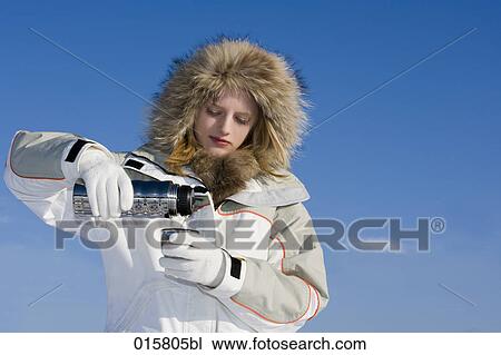 teenage girl in winter pouring hot drink from thermos bottle into mug View Large Photo Image Stock Image - teenage girl in winter pouring hot drink from thermos bottle into mug. Fotosearch