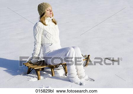 teenage girl sitting on sledge enjoying the winter sun View Large Photo Image Stock Image - teenage girl sitting on sledge enjoying the winter sun. Fotosearch