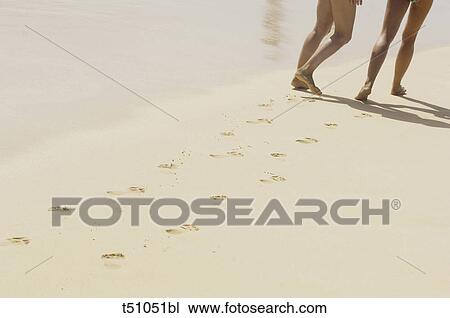 Two People walking on beach View Large Photo Image Stock Image - Two People walking on beach. Fotosearch