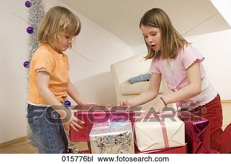 two sisters opening christmas presents View Large Photo Image Stock Image - two sisters opening christmas presents. Fotosearch