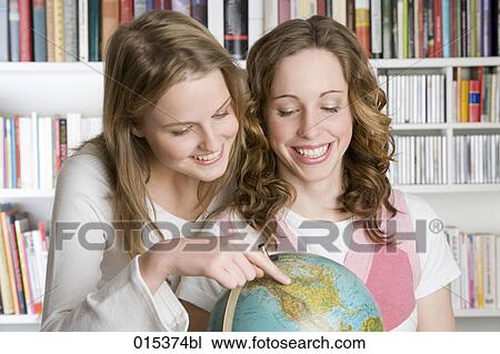 two teenage girls standing around globe View Large Photo Image Stock Image - two teenage girls standing around globe. Fotosearch