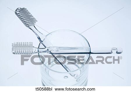 Two toothbrushes in a glass View Large Photo Image Stock Image - Two toothbrushes in a glass. Fotosearch