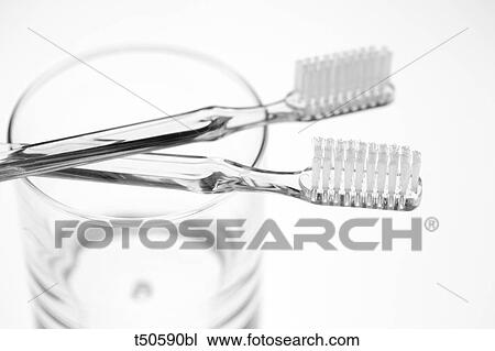 Stock Image - Two toothbrushes in a glass. Fotosearch