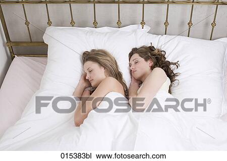 two young women sleeping together in bed View Large Photo Image Stock Image - two young women sleeping together in bed. Fotosearch
