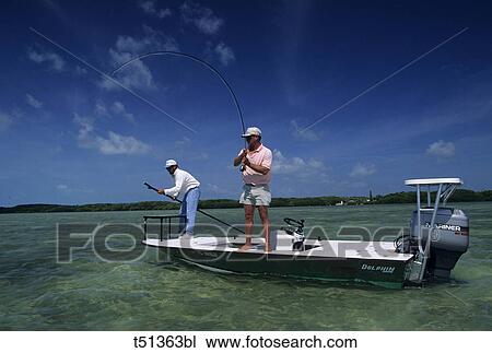 USA, Florida, Keys, man fly fishing from boat View Large Photo Image Stock Image - USA, Florida, Keys, man fly fishing from boat. Fotosearch
