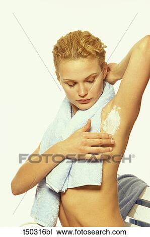 Woman applying depilatory cream under her armpit View Large Photo Image Stock Image - Woman applying depilatory cream under her armpit. Fotosearch