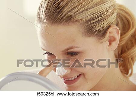 Woman applying moisturizer View Large Photo Image Stock Image - Woman applying moisturizer. Fotosearch