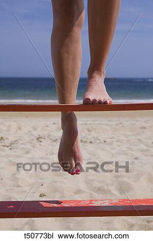 Woman at Beach next to lifeguard stand View Large Photo Image Stock Image - Woman at Beach next to lifeguard stand. Fotosearch