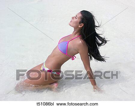 Woman at sea in shallow water View Large Photo Image Stock Image - Woman at sea in shallow water. Fotosearch