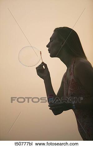 Woman blowing bubbles View Large Photo Image Stock Image - Woman blowing bubbles. Fotosearch