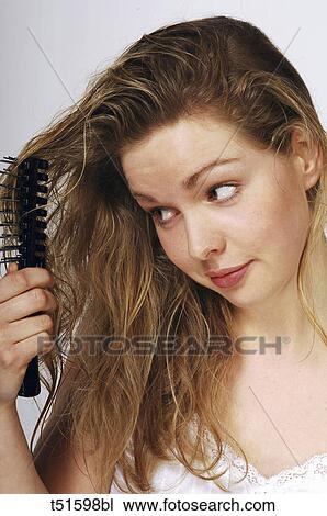 Woman brushing hair View Large Photo Image Stock Image - Woman brushing hair. Fotosearch