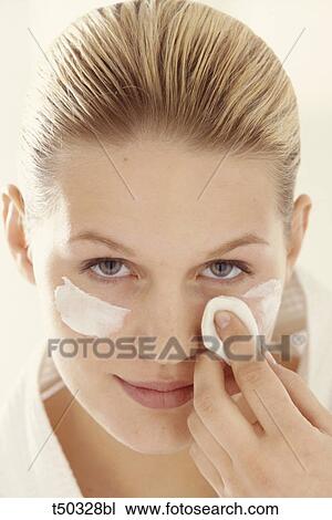 Woman cleaning her face with cotton View Large Photo Image Stock Image - Woman cleaning her face with cotton. Fotosearch