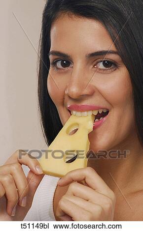 Woman eating a slice of cheese View Large Photo Image Stock Image - Woman eating a slice of cheese. Fotosearch