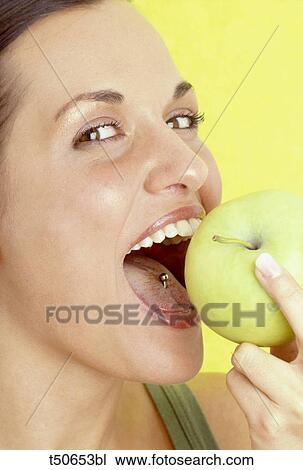 Stock Image - Woman eating an apple. Fotosearch