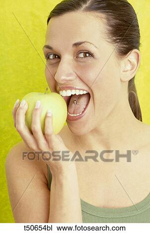 Woman eating an apple View Large Photo Image Stock Image - Woman eating an apple. Fotosearch
