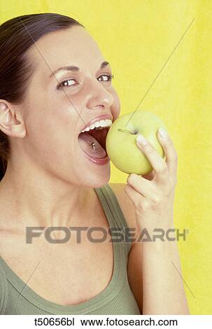 Woman eating an apple View Large Photo Image Stock Image - Woman eating an apple. Fotosearch
