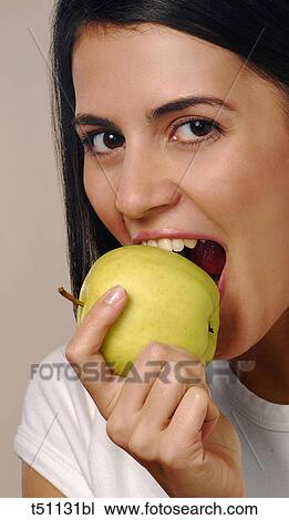 Stock Image - Woman eating an apple. Fotosearch