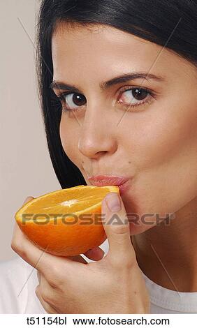 Woman eating orange View Large Photo Image Stock Image - Woman eating orange. Fotosearch