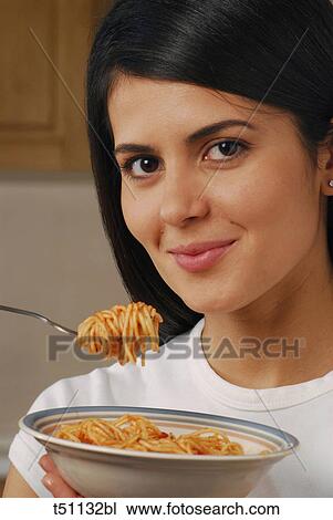 Woman eating pasta View Large Photo Image Stock Image - Woman eating pasta. Fotosearch