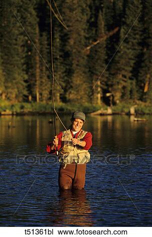 Woman fly fishing View Large Photo Image Stock Image - Woman fly fishing. Fotosearch