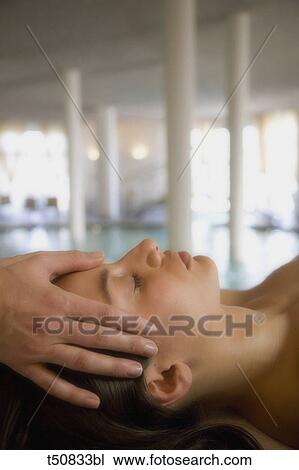 Stock Image - Woman getting head massage. Fotosearch