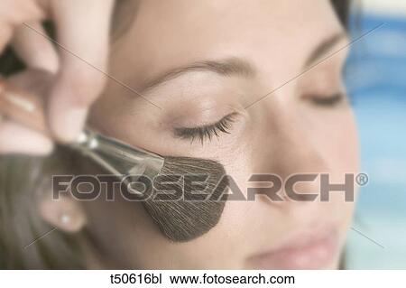 Woman getting made up View Large Photo Image Stock Image - Woman getting made up. Fotosearch