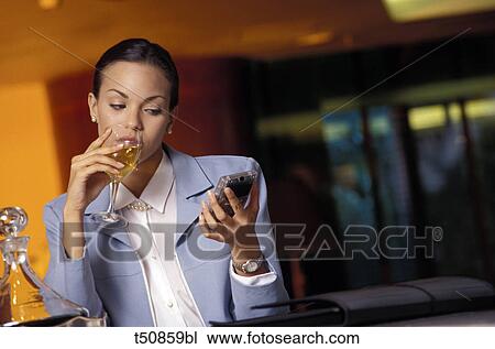 Woman having a glass of white wine View Large Photo Image Stock Image - Woman having a glass of white wine. Fotosearch