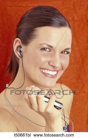Woman holding MP3 player View Large Photo Image Stock Image - Woman holding MP3 player. Fotosearch