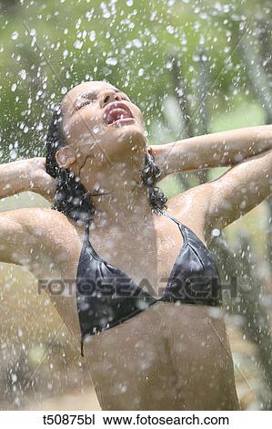 Woman in swimsuit having a shower View Large Photo Image Stock Image - Woman in swimsuit having a shower. Fotosearch