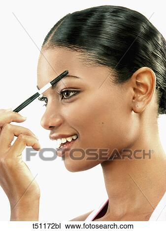 Woman making herself up View Large Photo Image Stock Image - Woman making herself up. Fotosearch