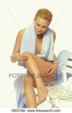 Woman plucking her legs with tweezers View Large Photo Image Stock Image - Woman plucking her legs with tweezers. Fotosearch
