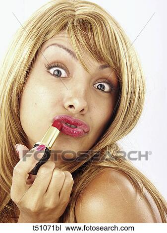 Woman putting lipstick on View Large Photo Image Stock Image - Woman putting lipstick on. Fotosearch