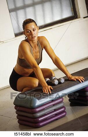 Woman resting after working out in gym View Large Photo Image Stock Image - Woman resting after working out in gym. Fotosearch